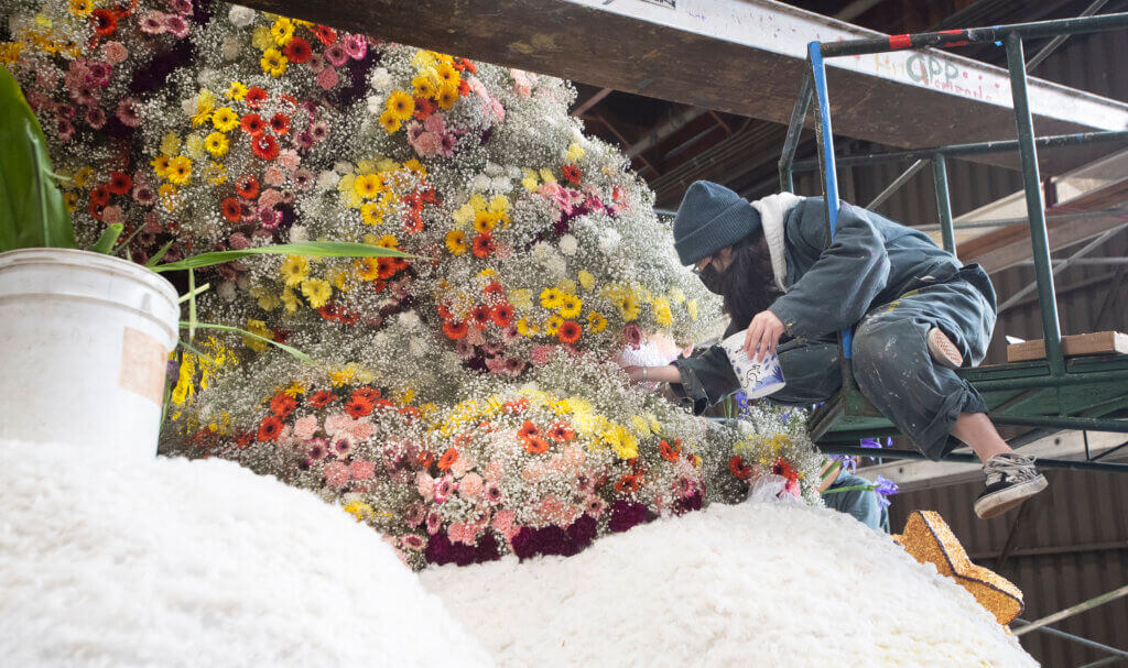 Students from both Cal Poly campuses applied flowers to their float prior to the parade.