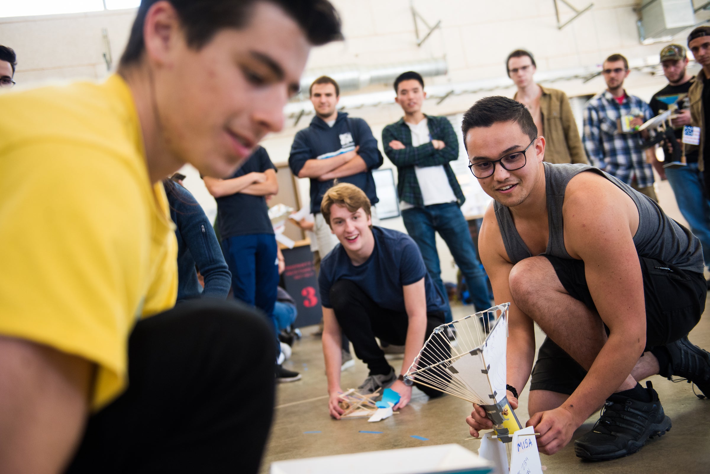 Engineering students testing popsicle builds