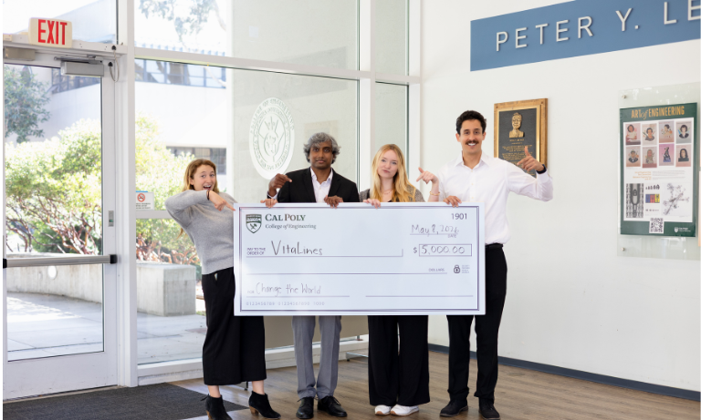 This year's Change the World: The Systems Thinking Challenge winners show off the giant check they were rewarded for their project, VitaLines. / Photo by Madeleine Munselle