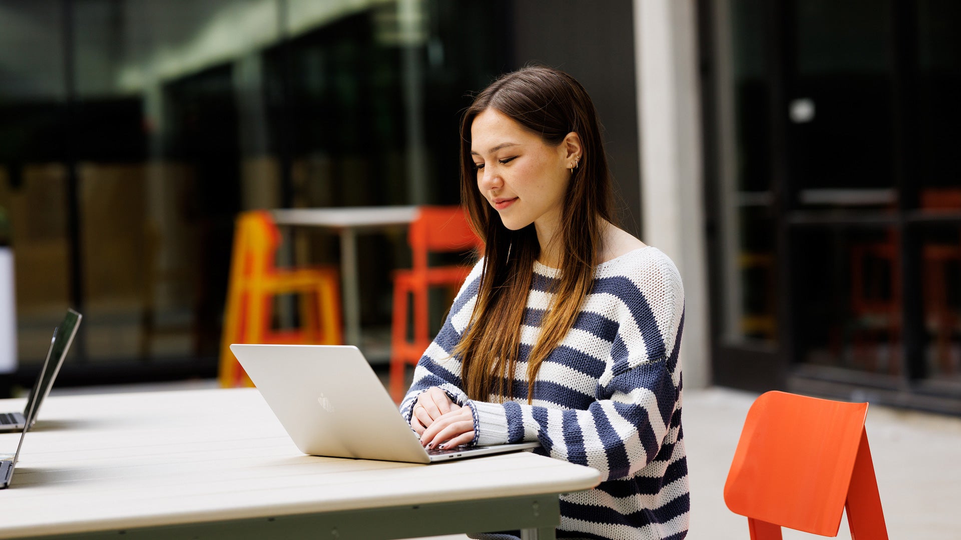 Student studying on laptop at the newly remodeled Robert E. Kennedy Library