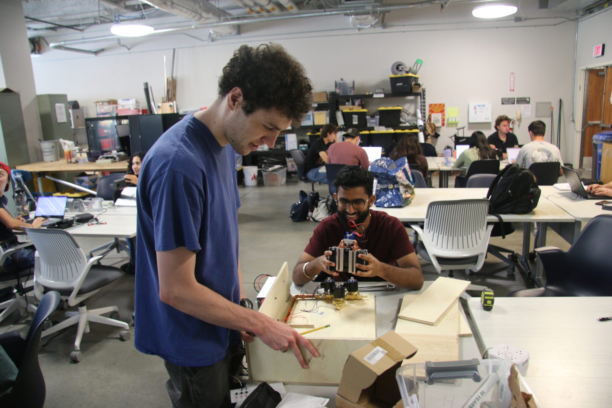 Mechanical engineering seniors Ethan Pace, left, and Tarsem Pal work on the PHAT prototype in the TECHE Lab before the team’s first-place finish in NASA’s 2026 Human Lander Challenge. The project was designed to add cold drinking water to spacecraft water dispensers for future lunar and Mars missions.