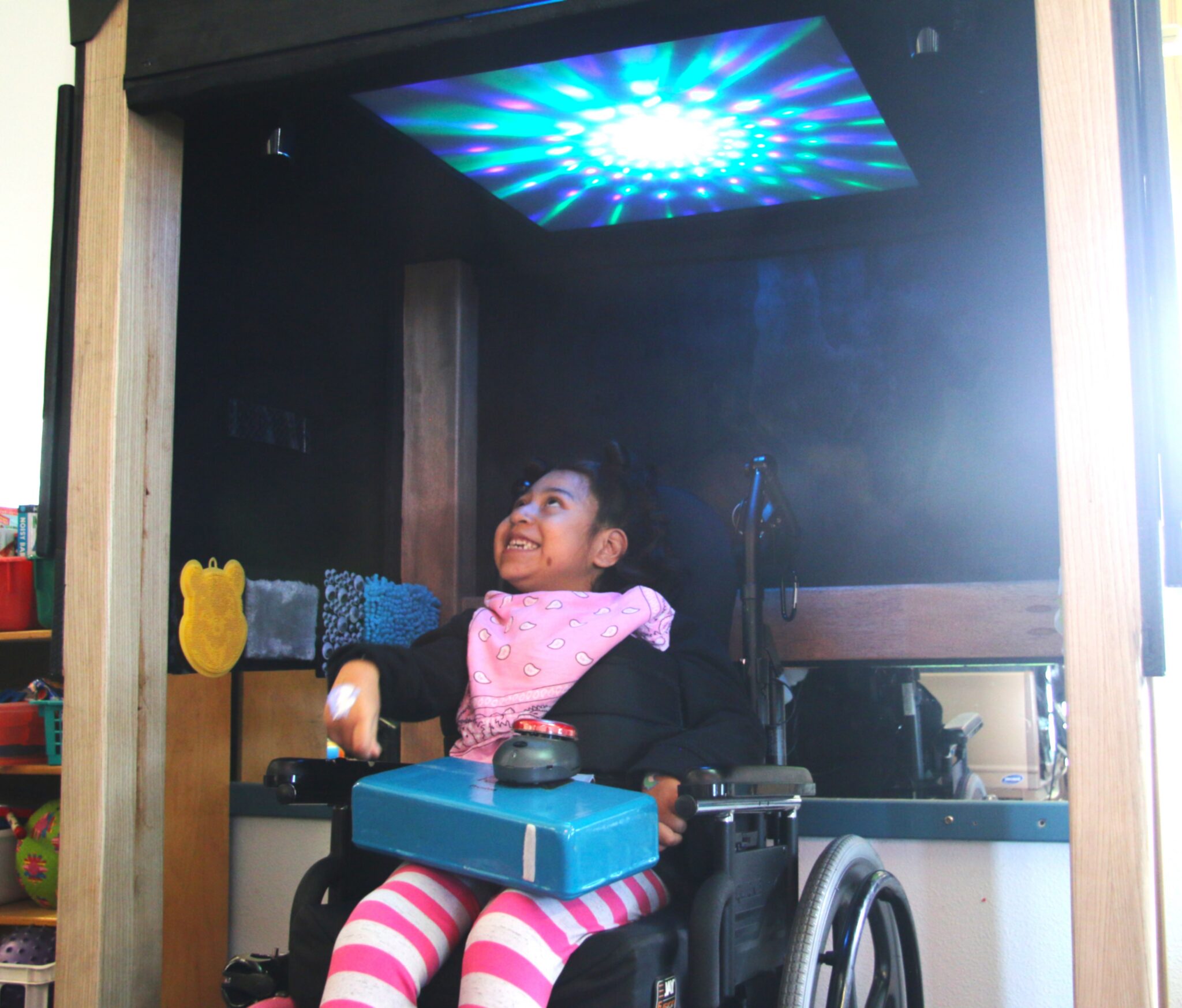 Marion looks up at the moving lights inside the sensory den after it was installed in Heather McColley’s classroom at Oceano Elementary School. 