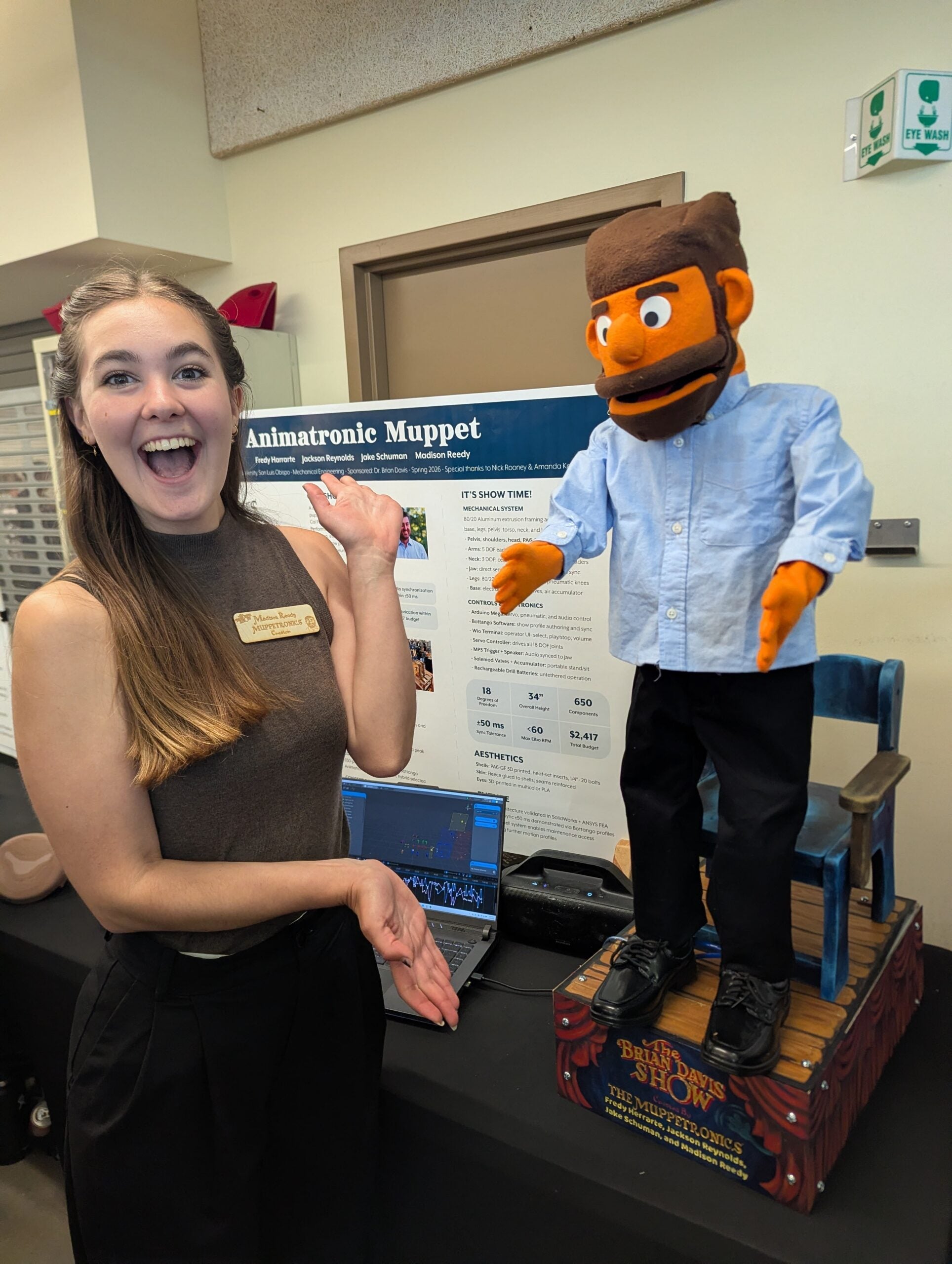 Maddy Reedy, whose classroom conversation with Brian Davis sparked the project, presents the finished animatronic puppet at Cal Poly’s Engineering Senior Project Expo. 