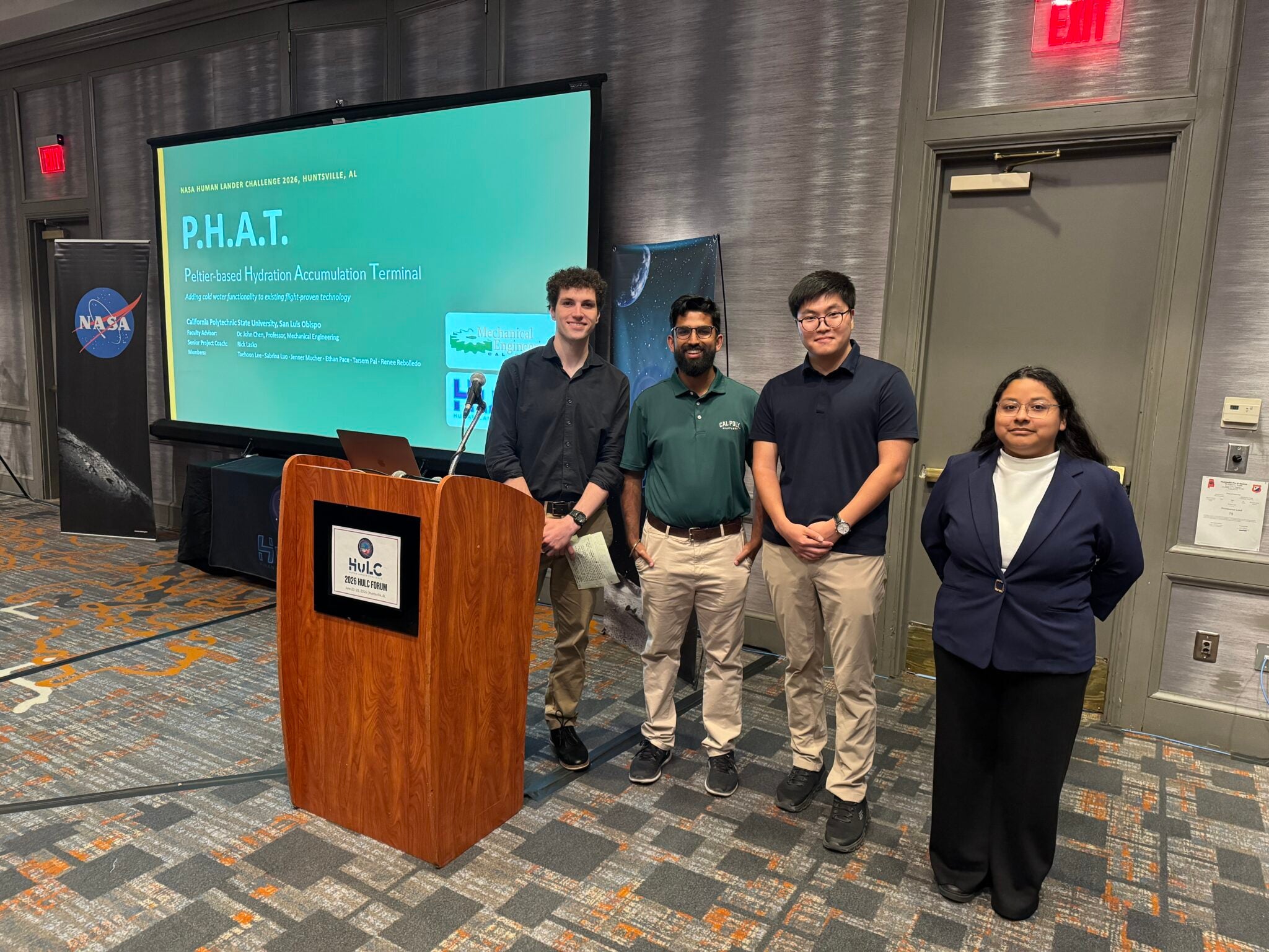 Cal Poly PHAT team members, from left, Ethan Pace, Tarsem Pal, Taehoon Lee and Renee Rebolledo stand near the podium after presenting their winning design at NASA’s 2026 Human Lander Challenge in Huntsville, Alabama. 