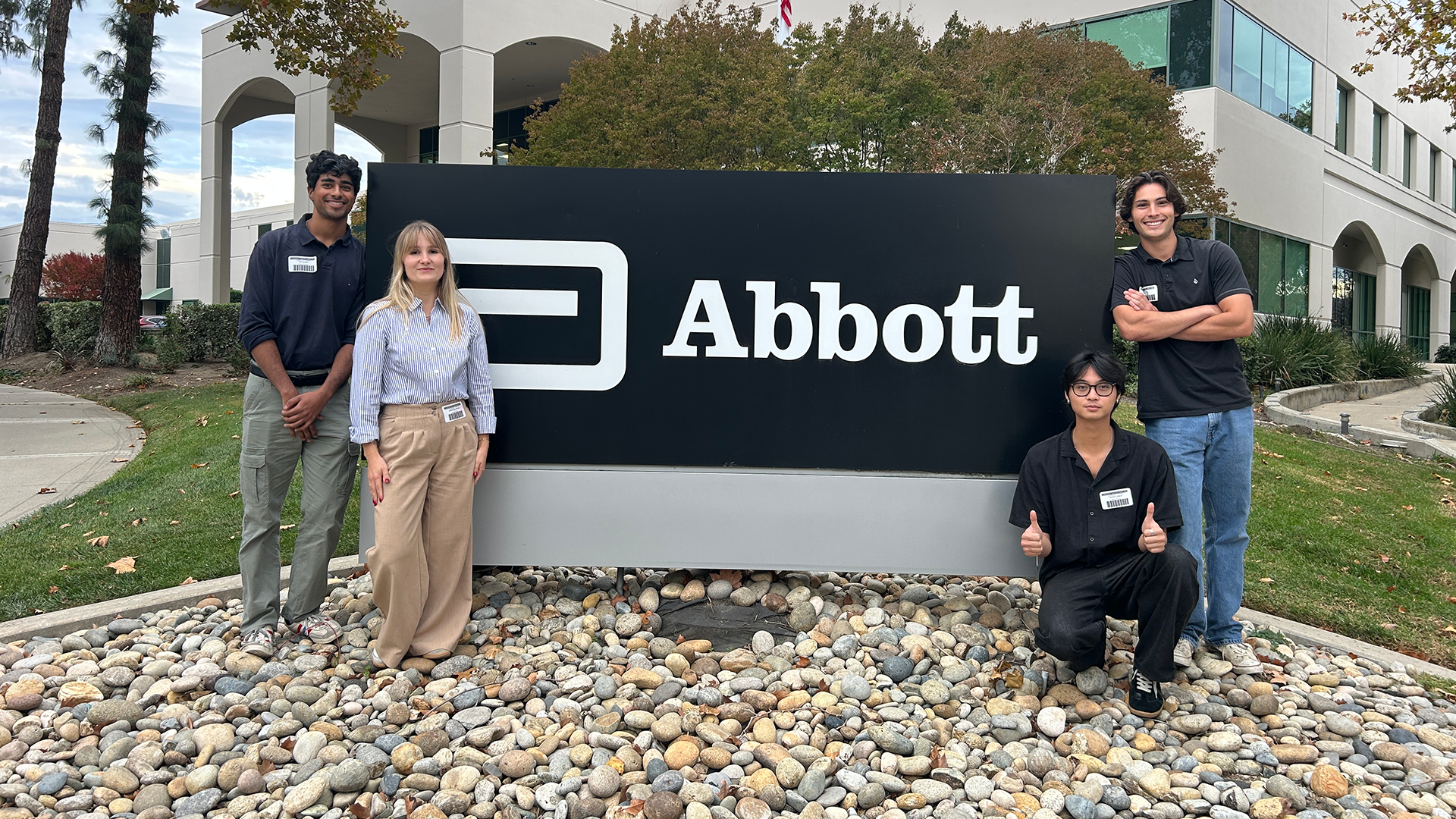Students pose with Abbott sign