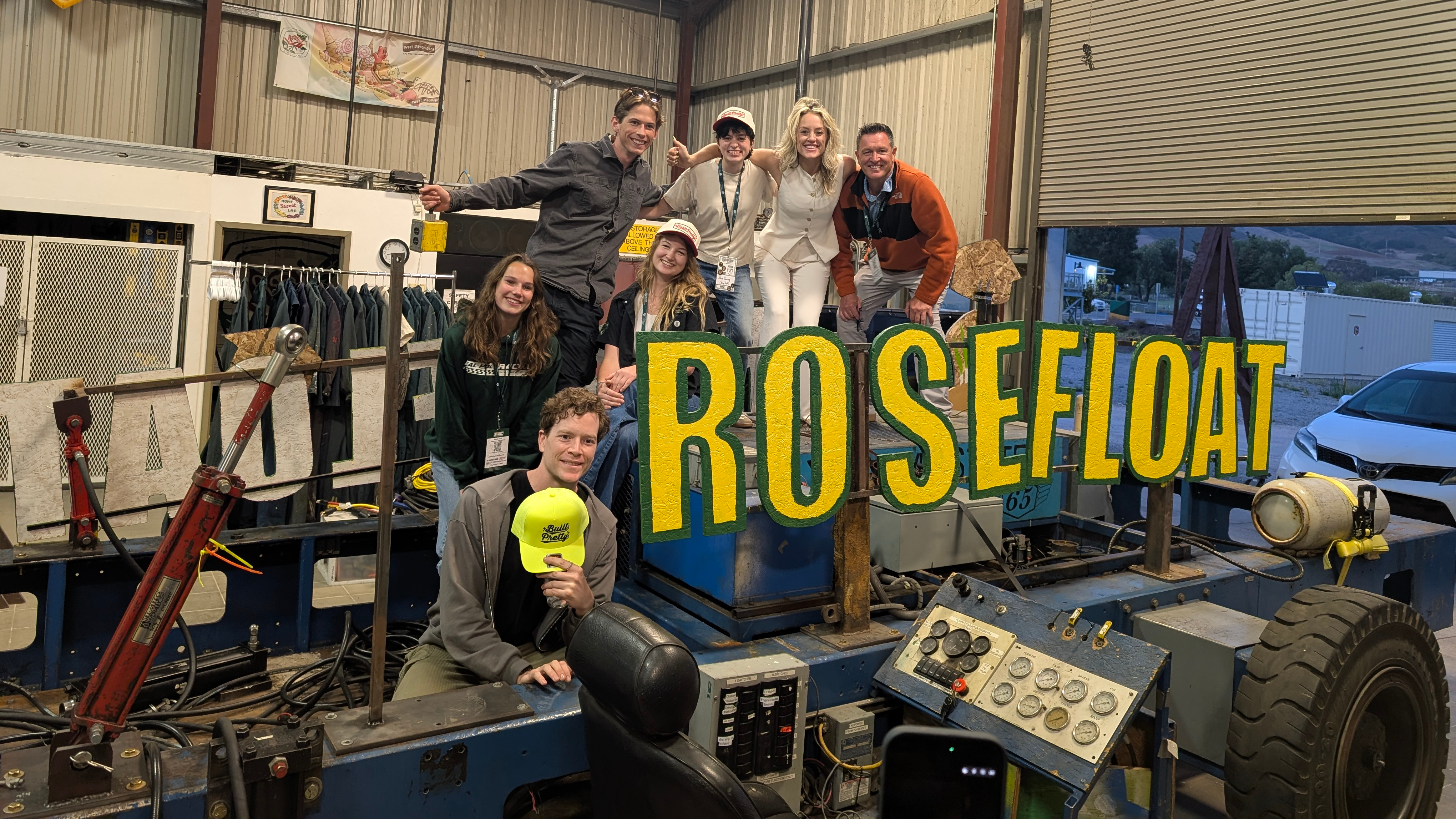 Conference participants gather with the Rose Float sign