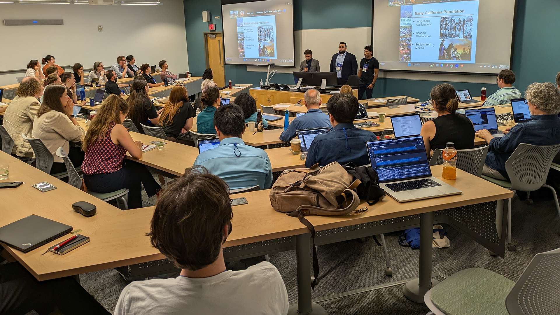 Students present to audience during conference