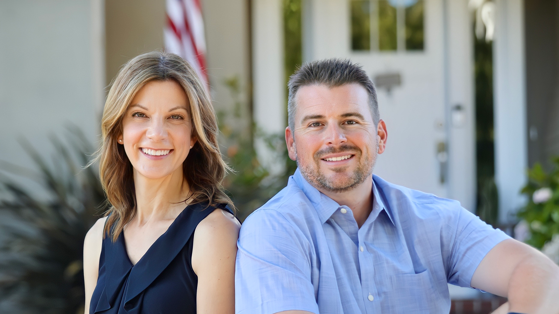 Couple pose for photo on porch