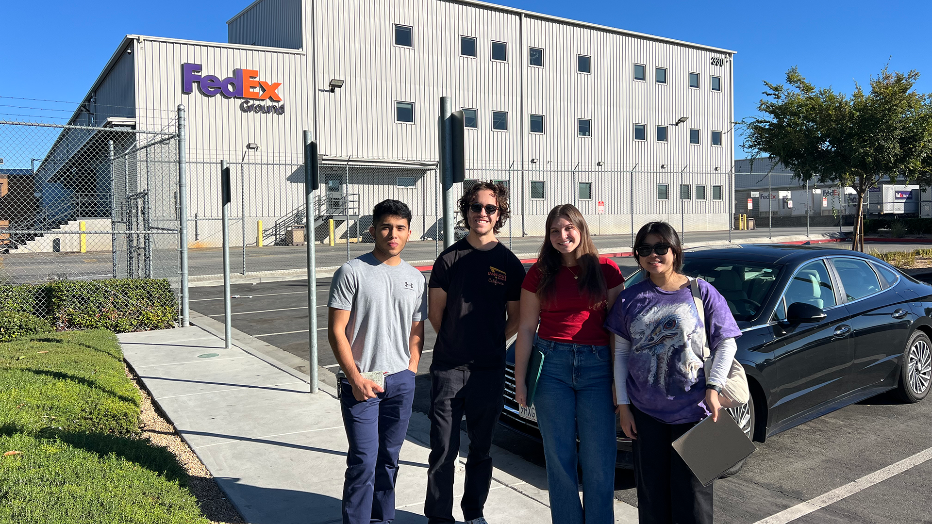 Students stand in front of FedEx facility