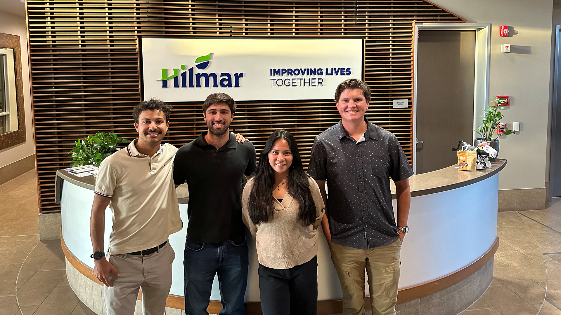 Students pose in front of Hilmar sign