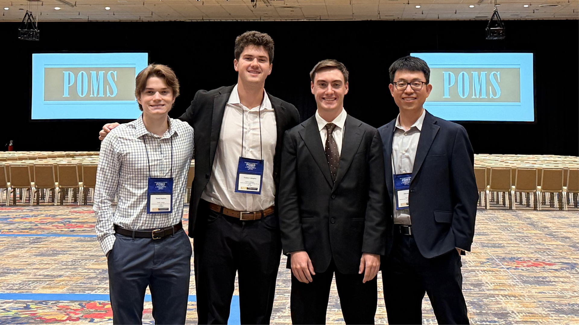 From left, industrial engineering students Daniel Hopkins, Tommy Gallagher and Michael Vieira represent Cal Poly with assistant professor Zhiyuan Wei at the 2026 Production and Operations Management Society Annual Conference.