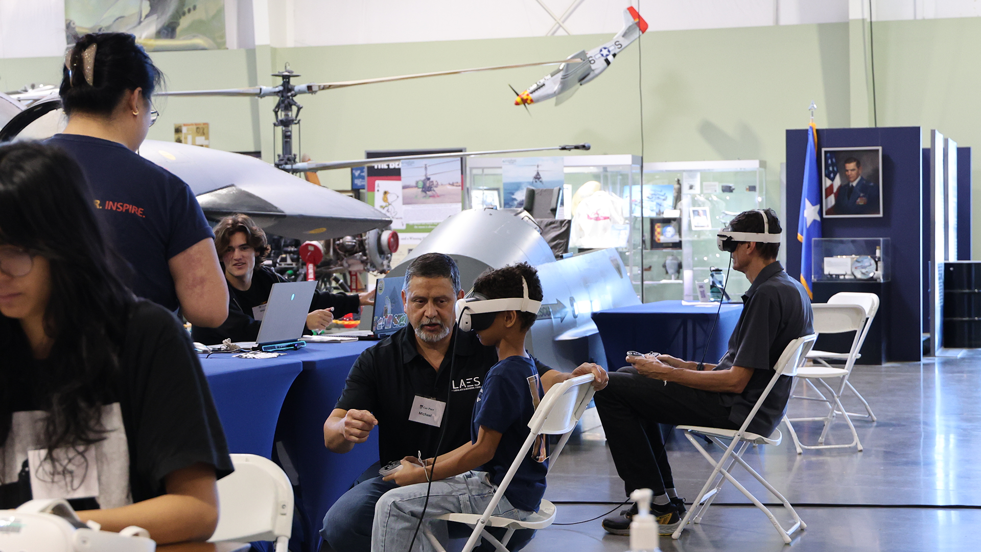 Professor helps a young tester at the museum test a VR experience