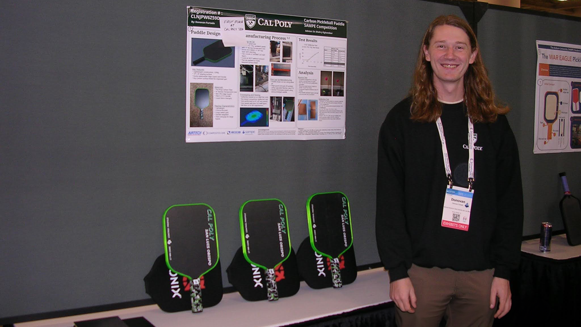 Mechanical engineering graduate Donovan Furtado stands with the poster and three carbon fiber paddles that earned first place in SAMPE’s inaugural Student Pickleball Paddle Design Competition. 