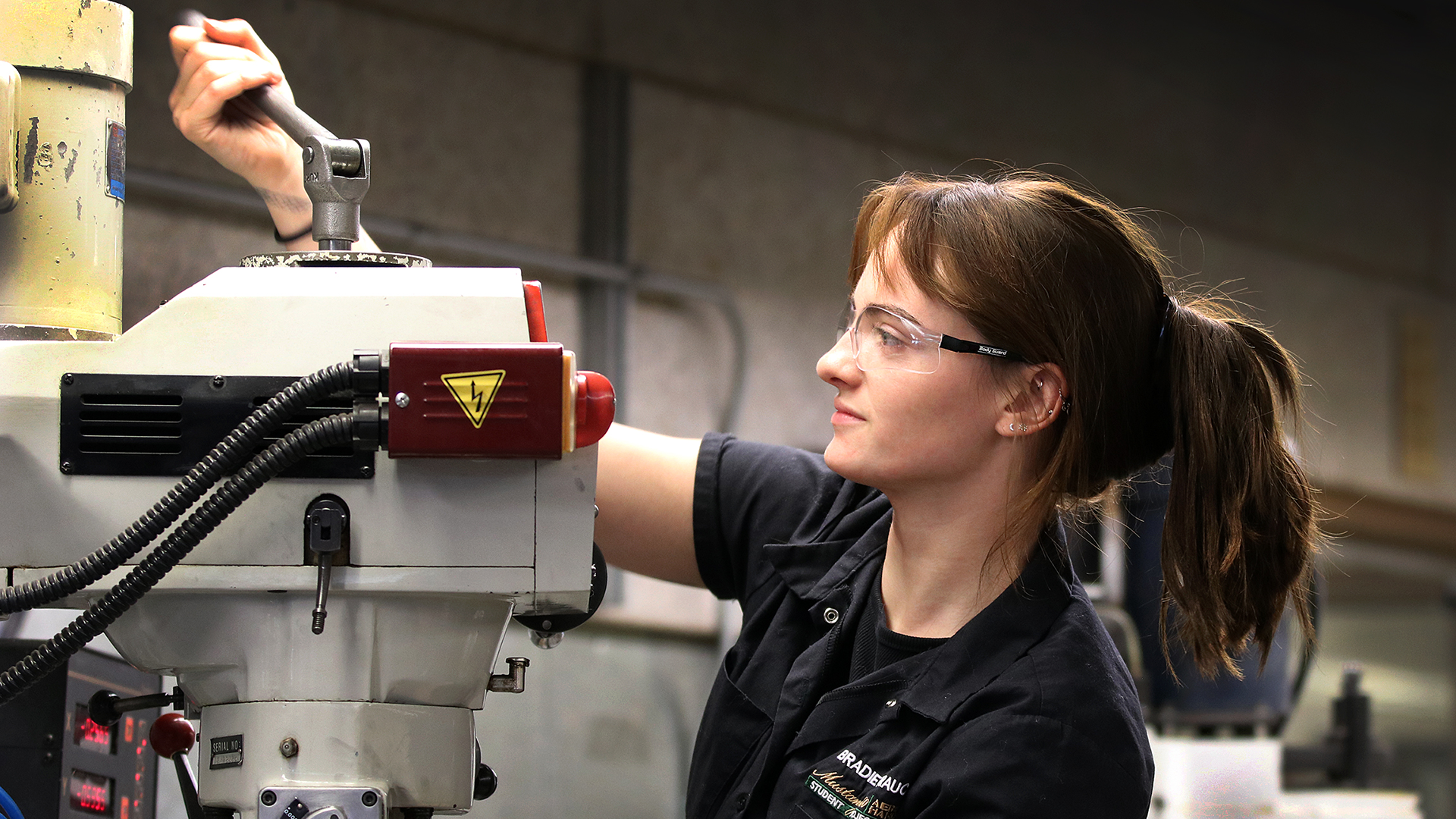 shop tech works on machine