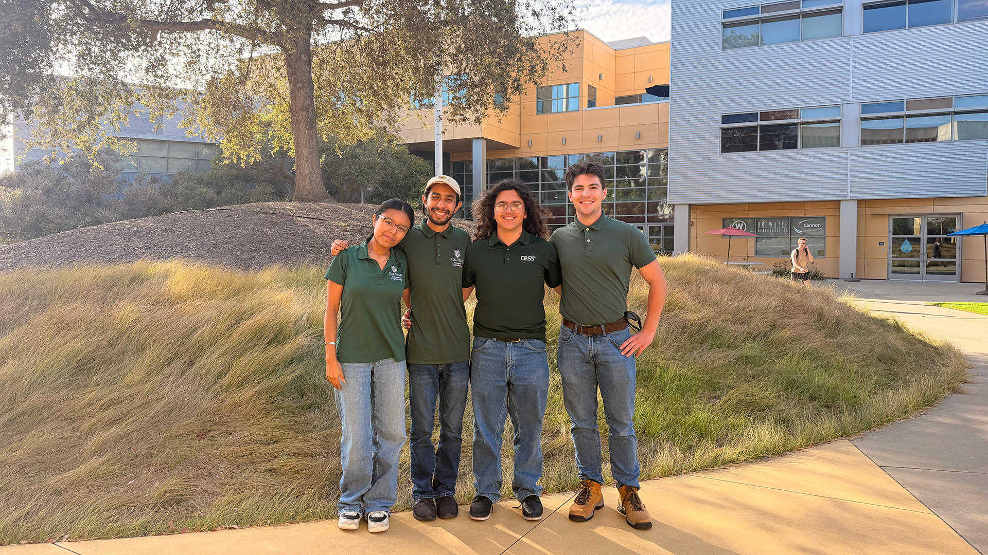 Group of friends pose in front of building