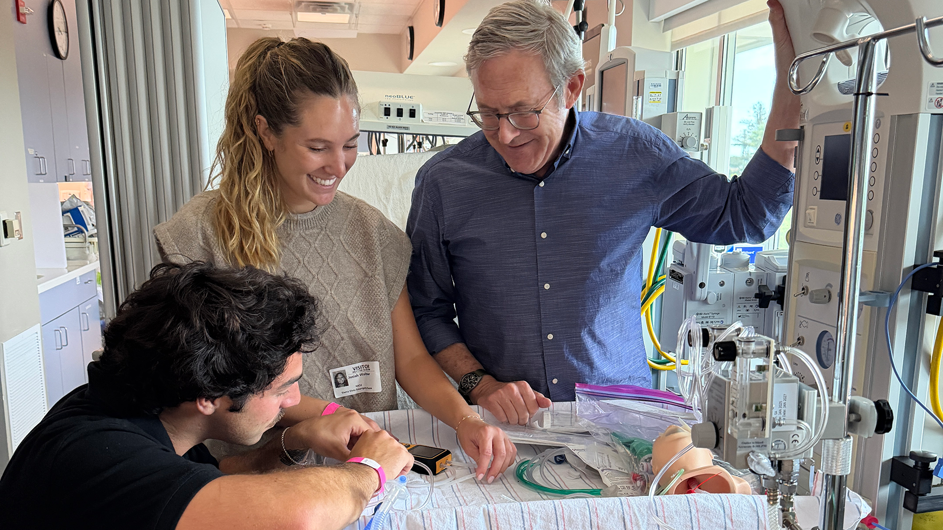 Students work with doctor in NICU