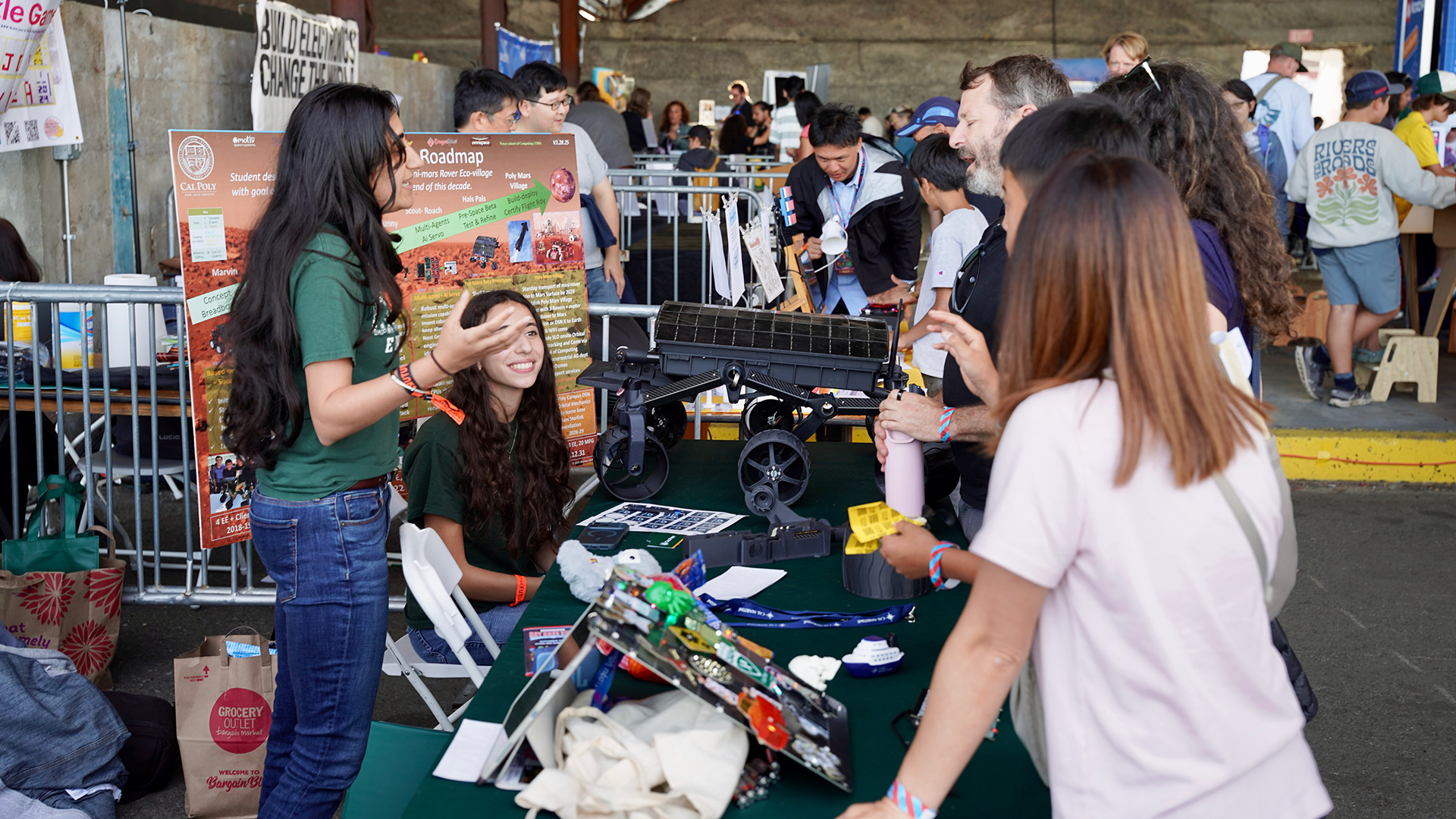 Students interact with visitors at the makers faire