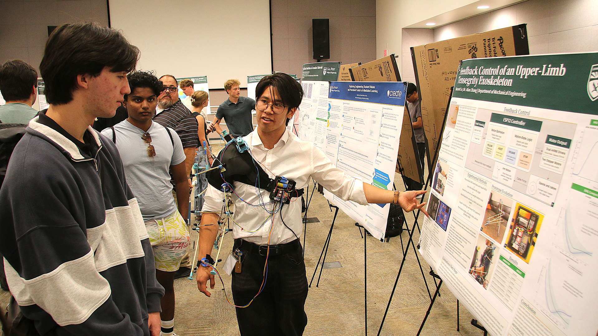 Student displays research poster while wearing device