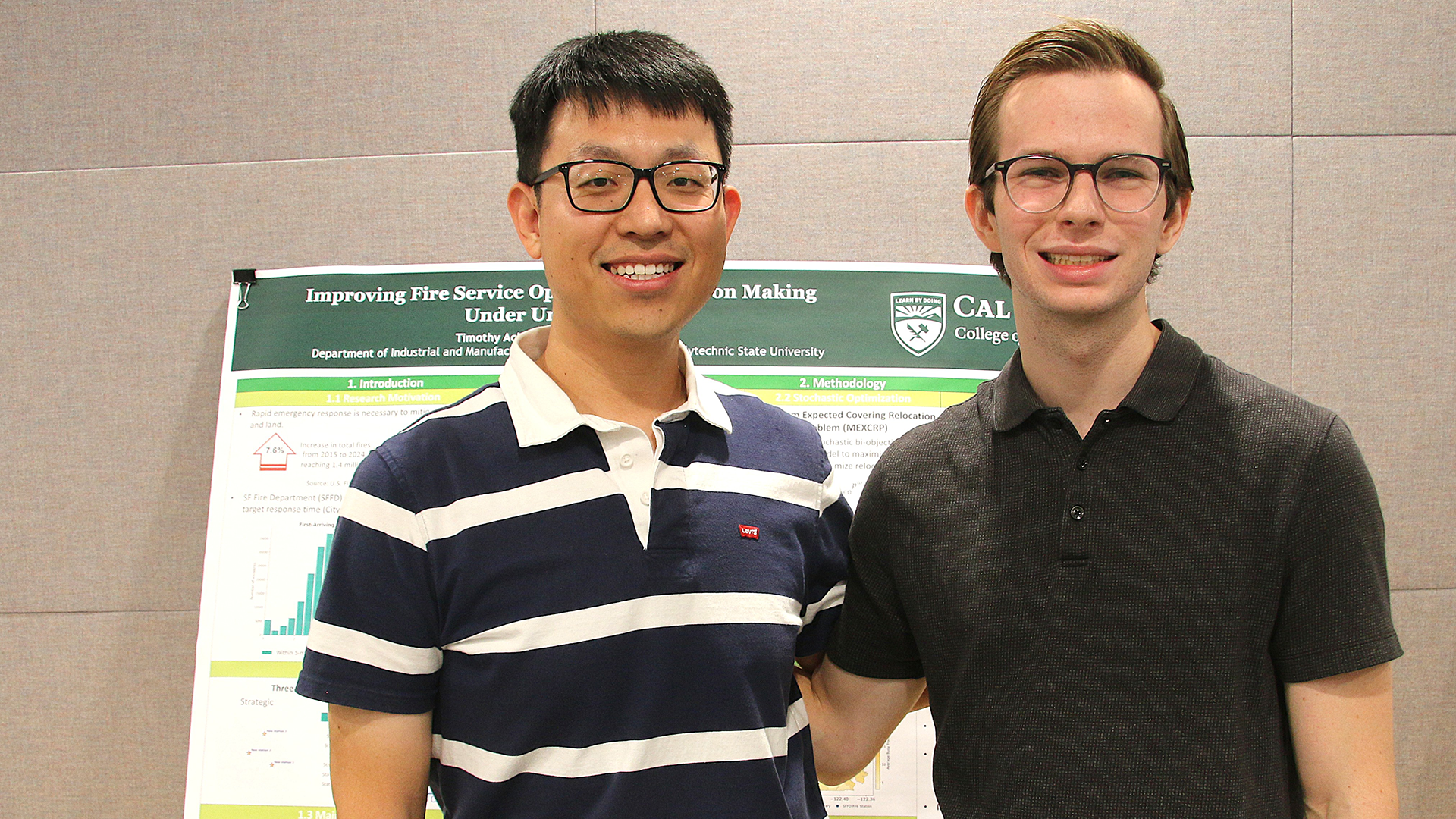 Student and professor pose next to research poster