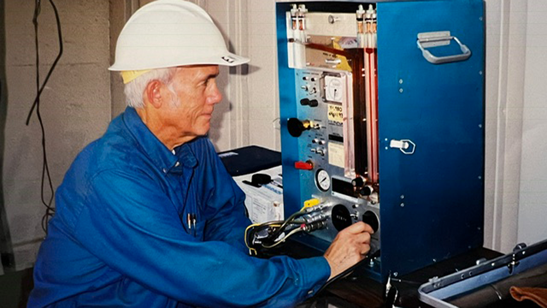 Hal Cota works in a lab with hard hat