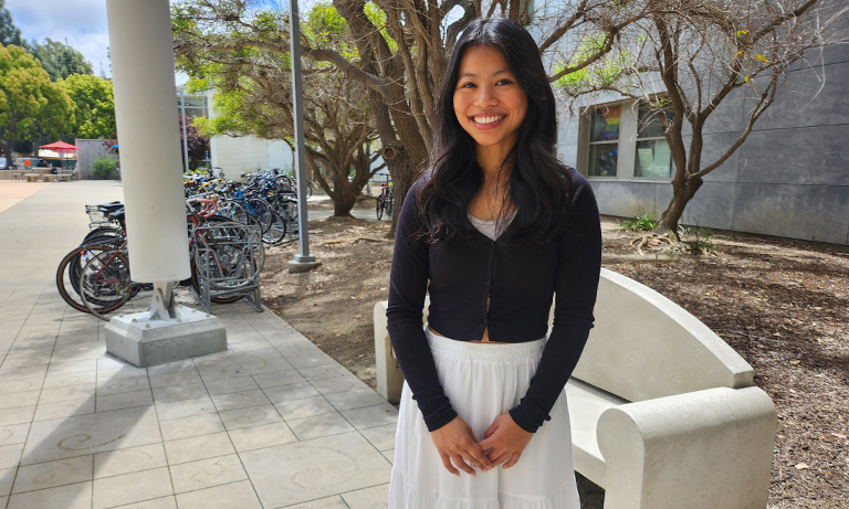 A student smiling at the camera