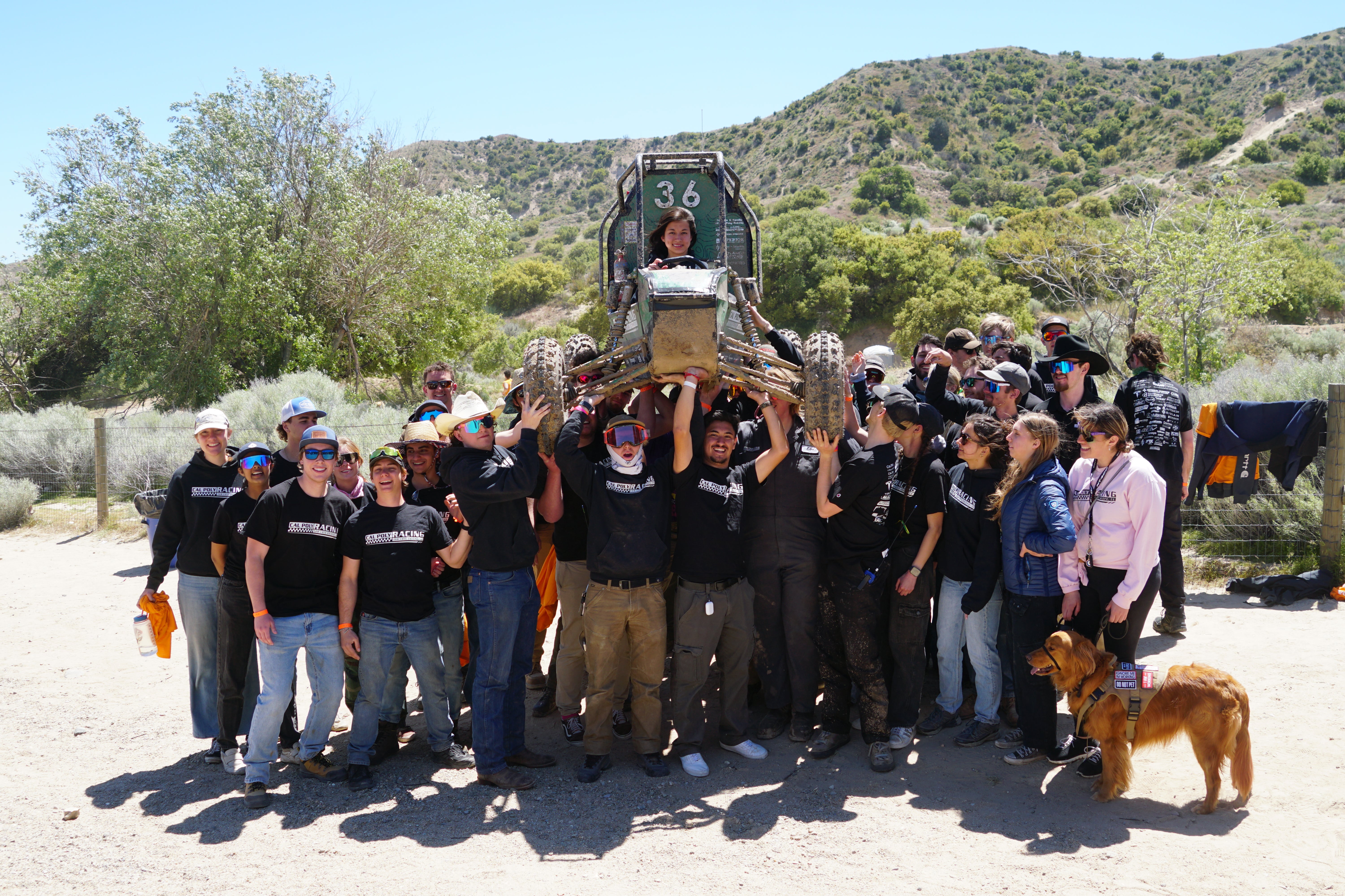 The Baja SAE team hoists their vehicle after completing their dynamic events in Gorman, California