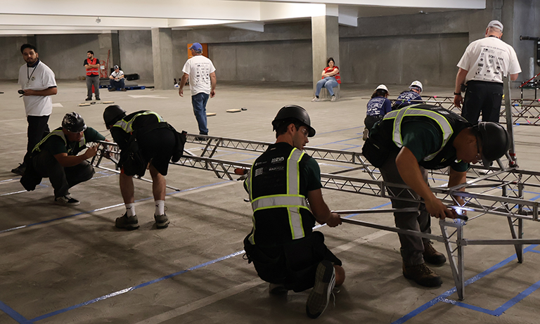 Students construct a steel bridge during competition