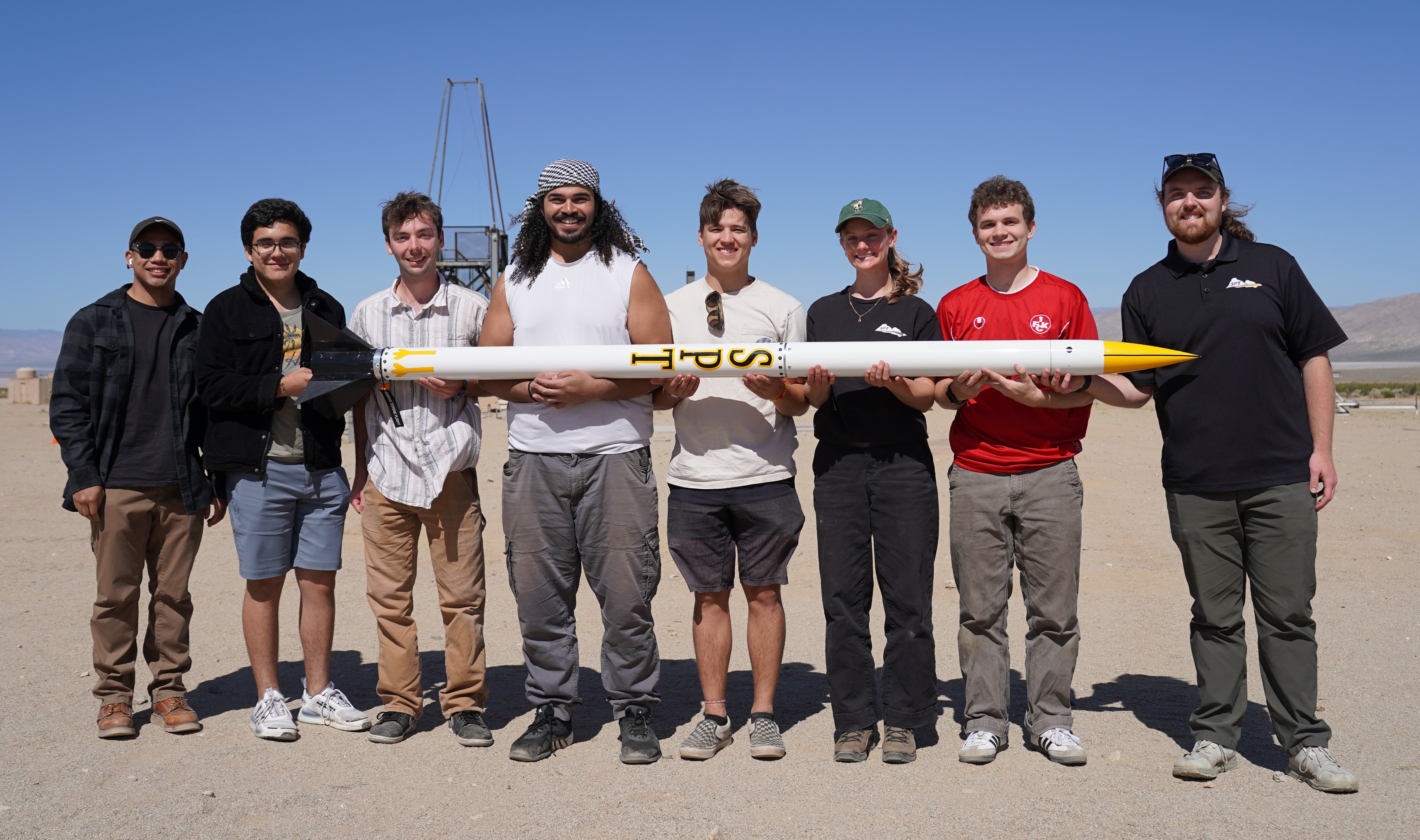Members of the Let it Loose team hold their rocket, Goose