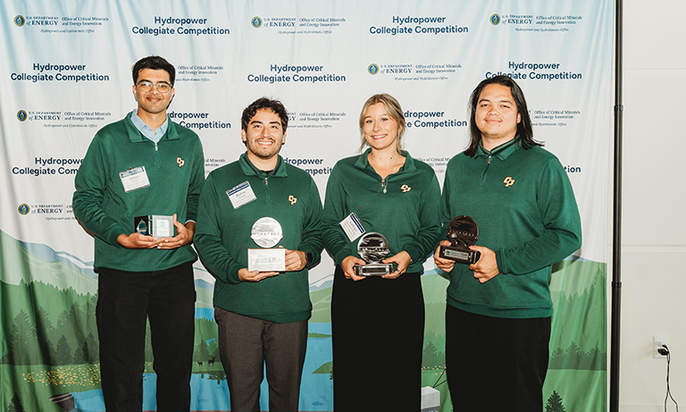 Team holds awards after competition