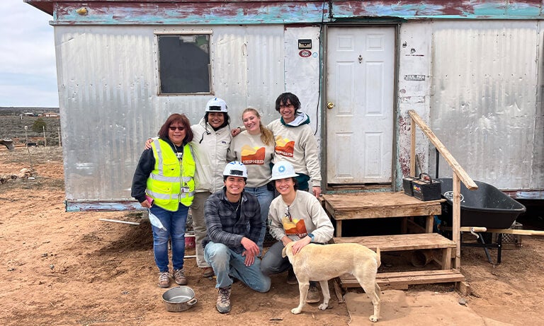 Students stand outside home on Navajo Nation