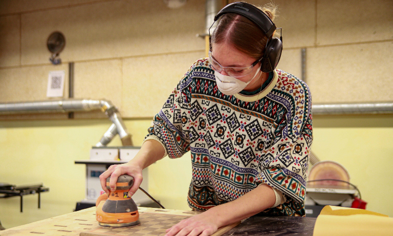 A student working at a machine shop