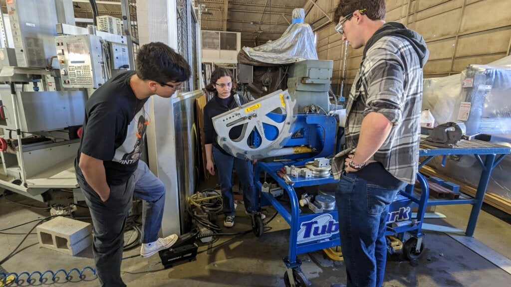 Manufacturing team members test tube bending for the track backbone