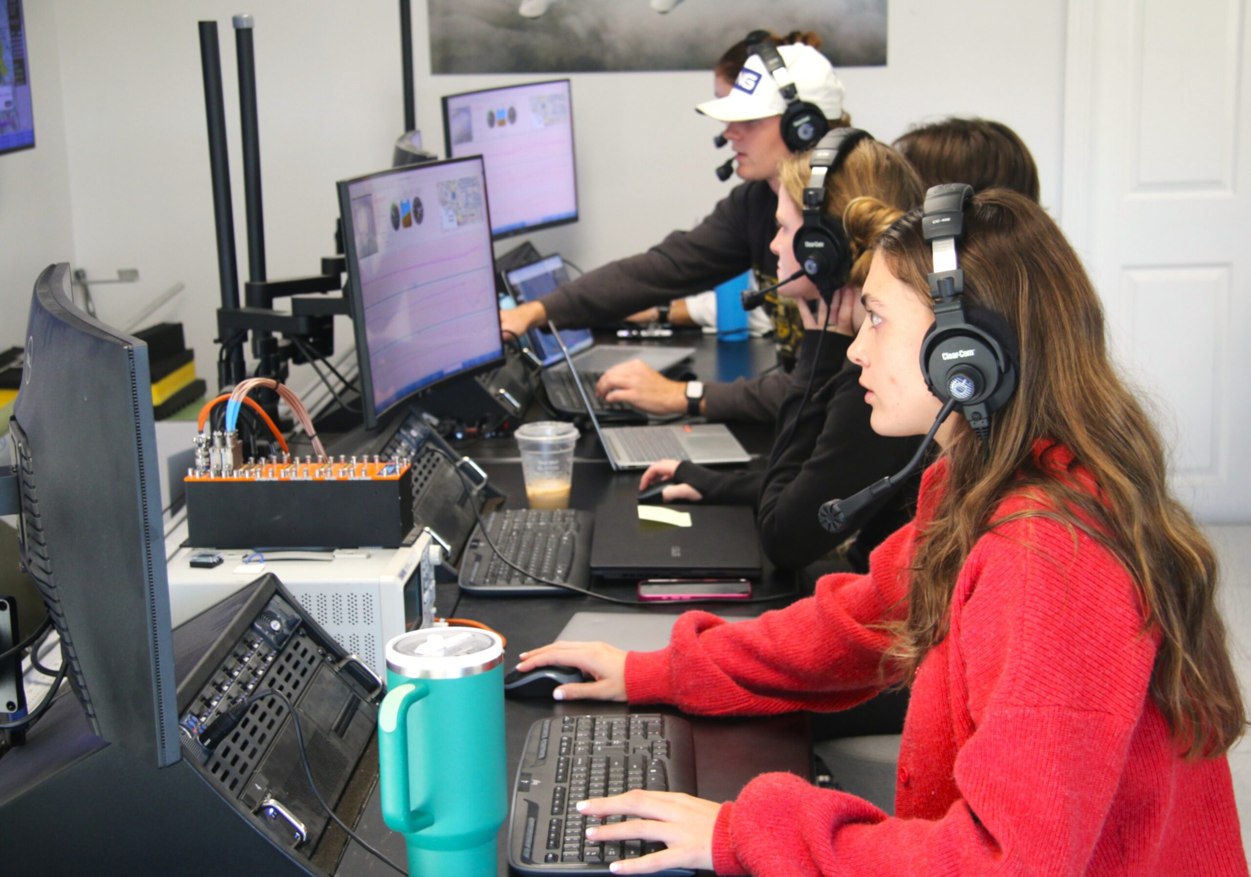 Students check monitors during a flight test