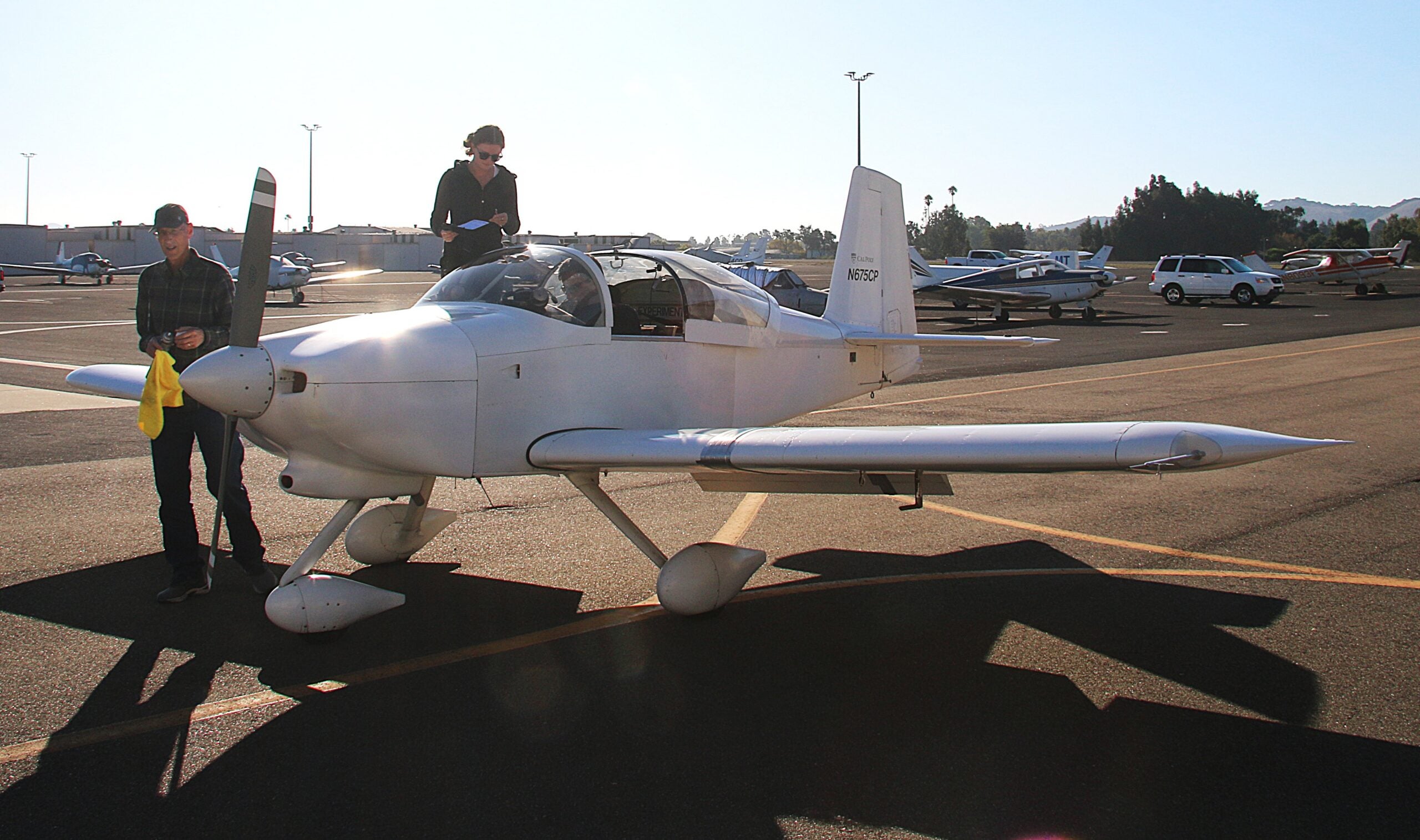Professors and student prepare the plane for takeoff