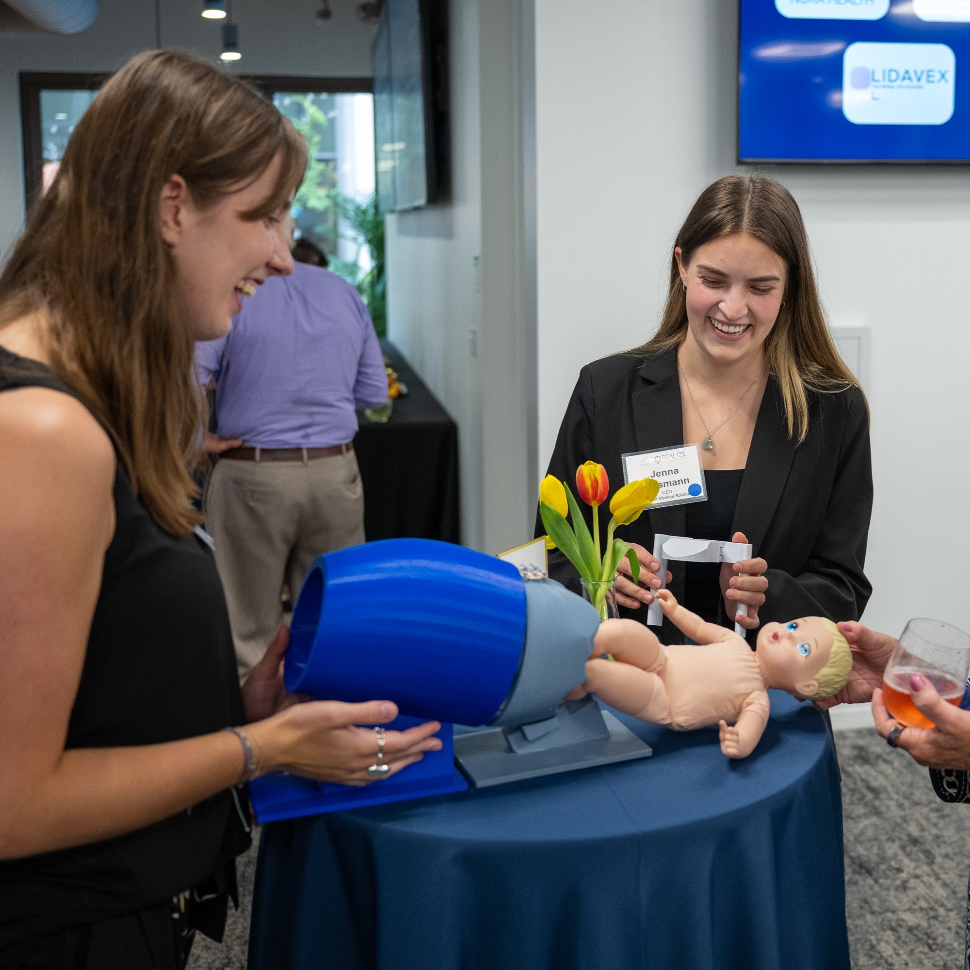 Co-founders demonstrate an early model designed to simulate maternal anatomy and a baby's shoulder mechanics during shoulder dystocia. 
