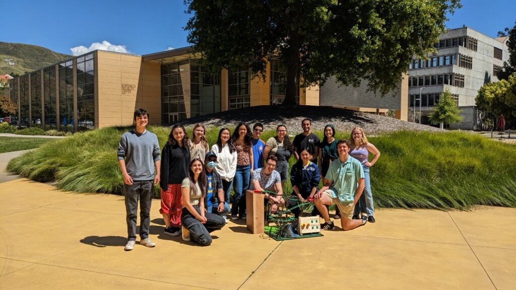 CAPED members pose in front of the Bonderson Projects Center with their model roller coaster