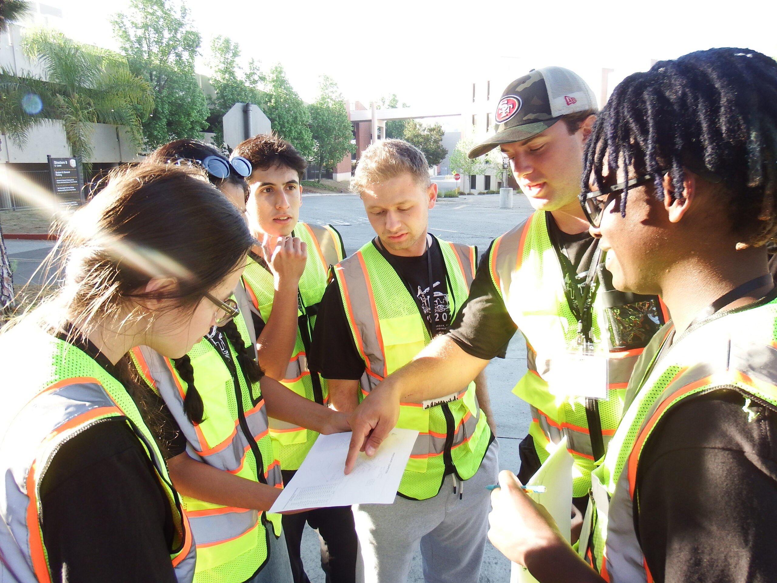Members of the surveying team review plans