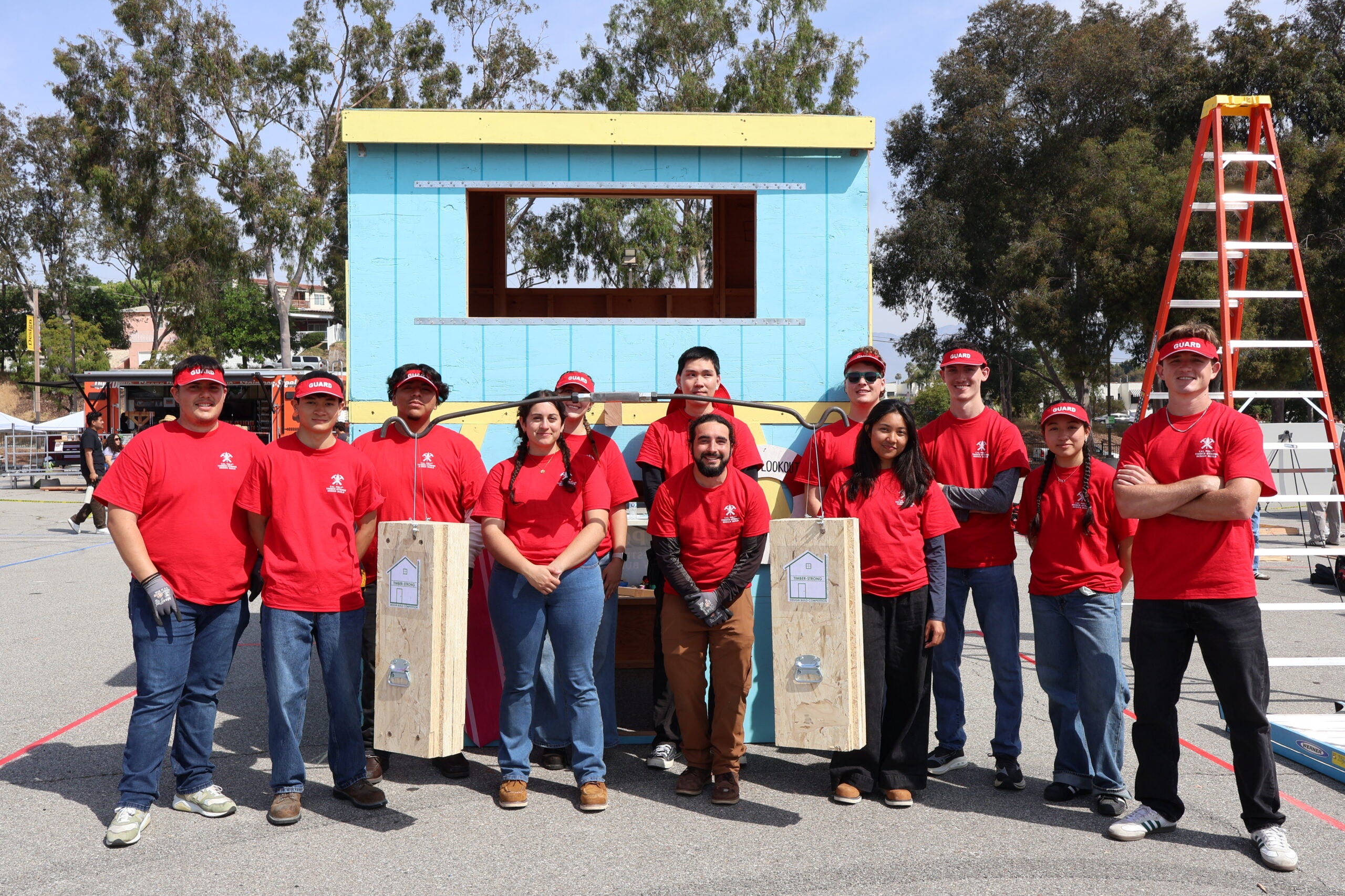Timber-Strong Design Build team pose for a group shot with their structure