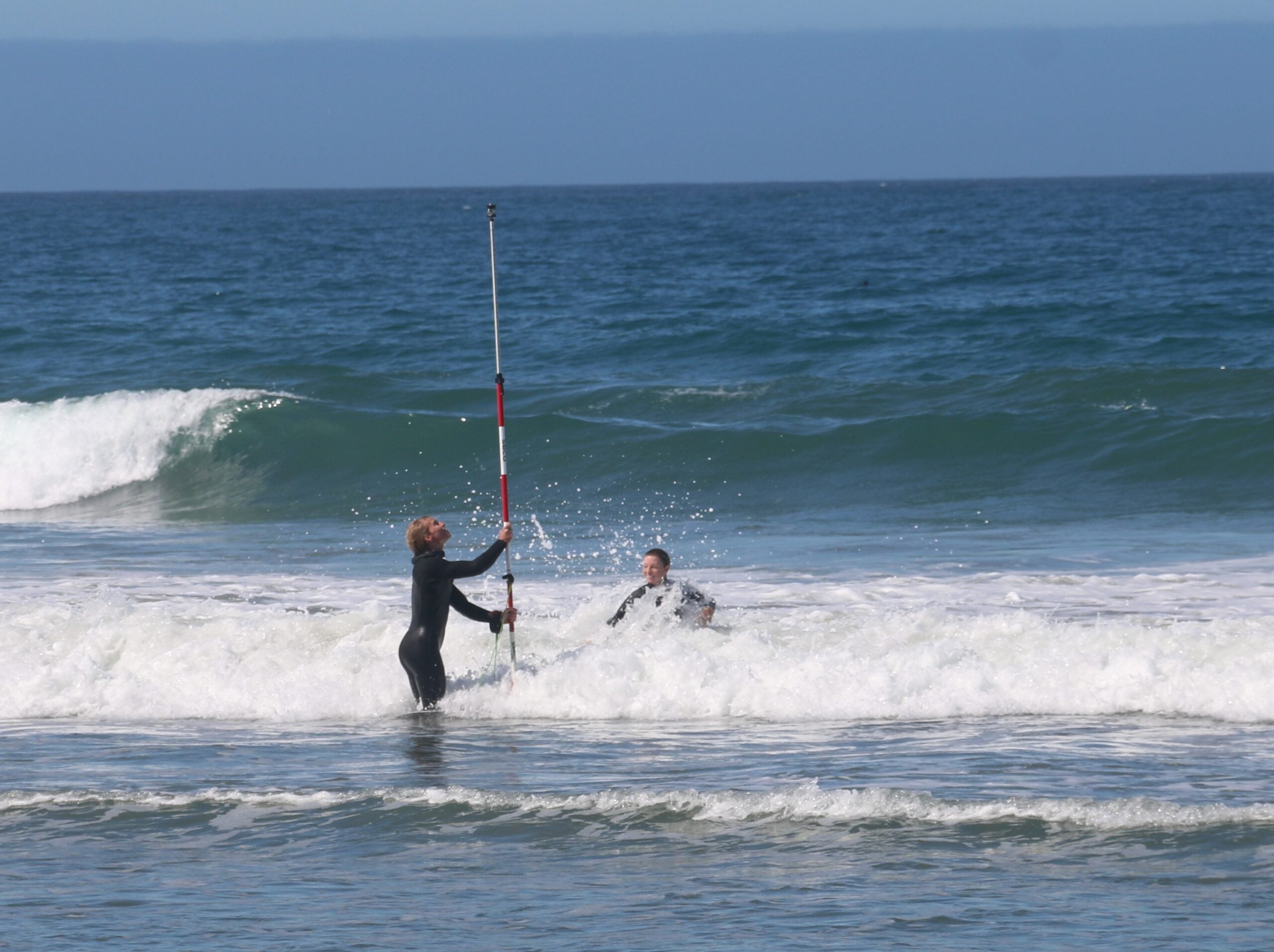 Researcher and student conduct fieldwork at Toro Creek Beach