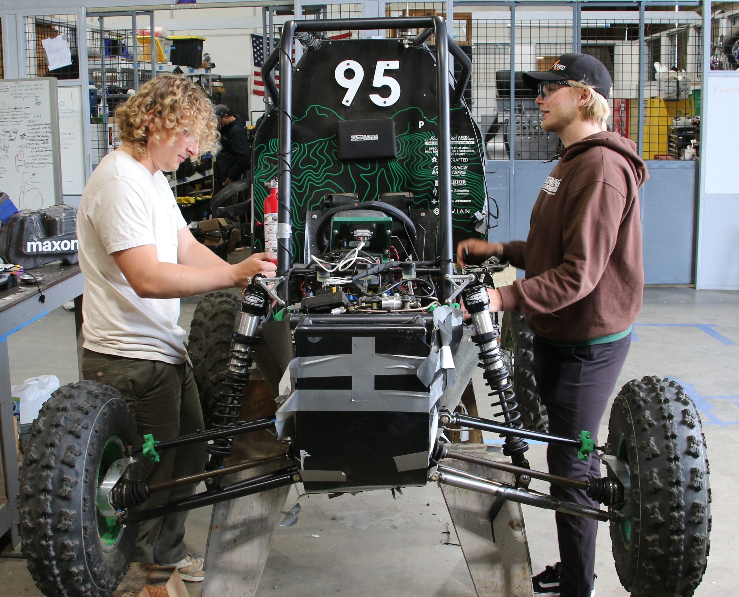 Students work on car in the shop