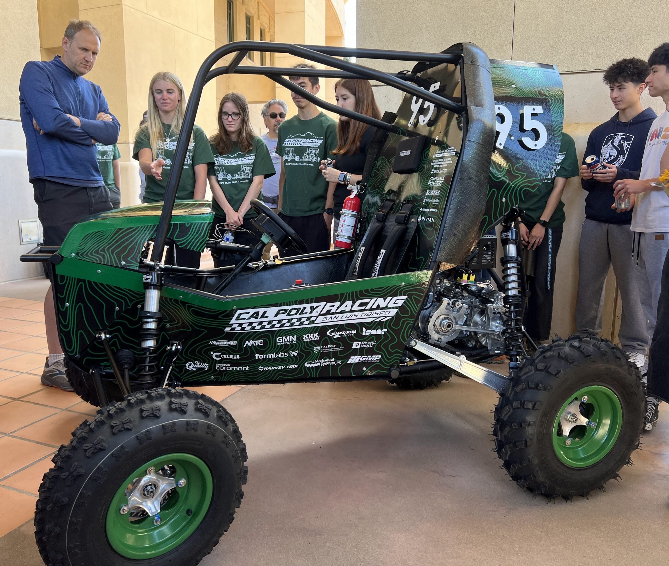Car revealed during Open House. Students show features to visitors 