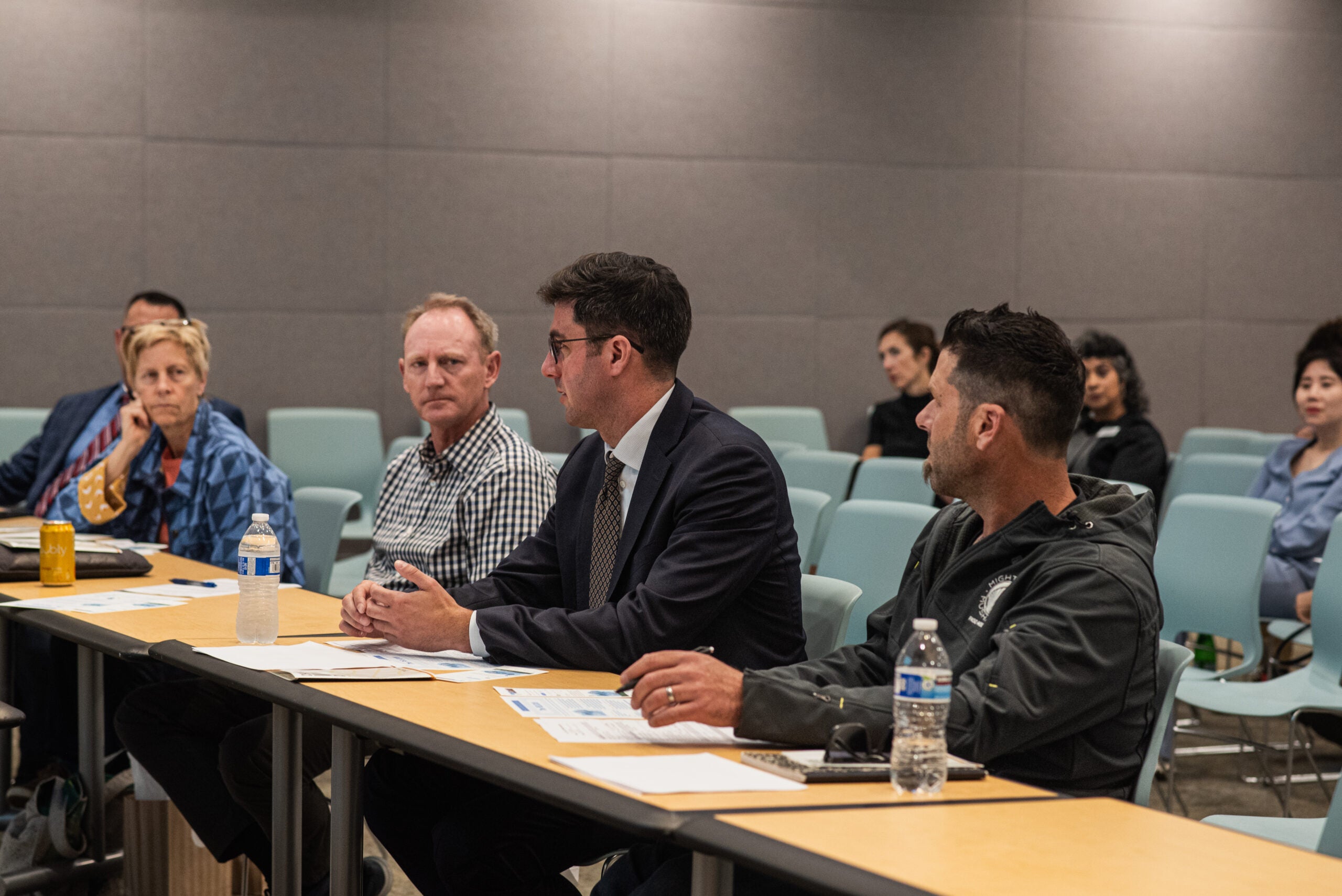 People sitting in a row listening to a presentation