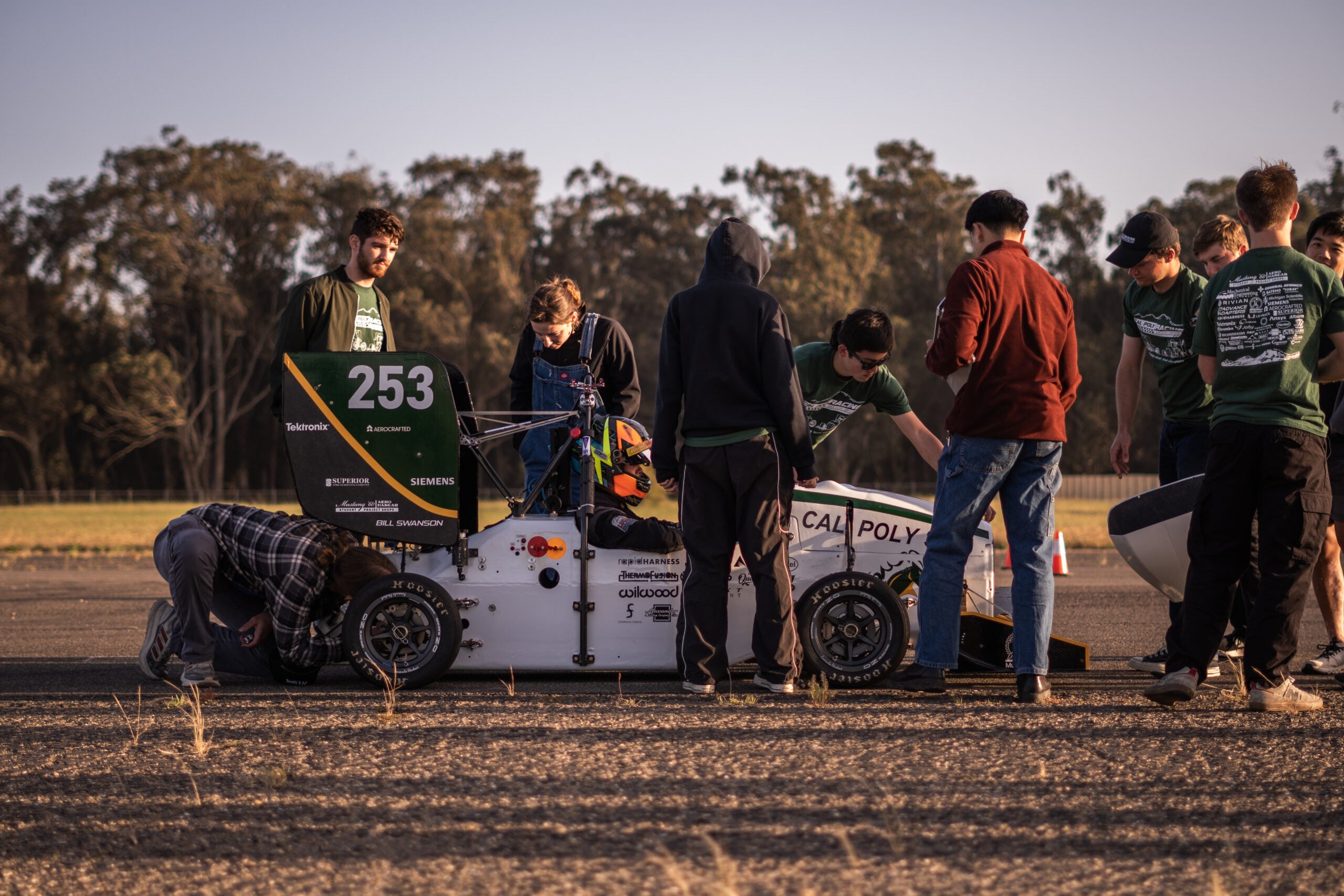 Team members check out the car during a test session