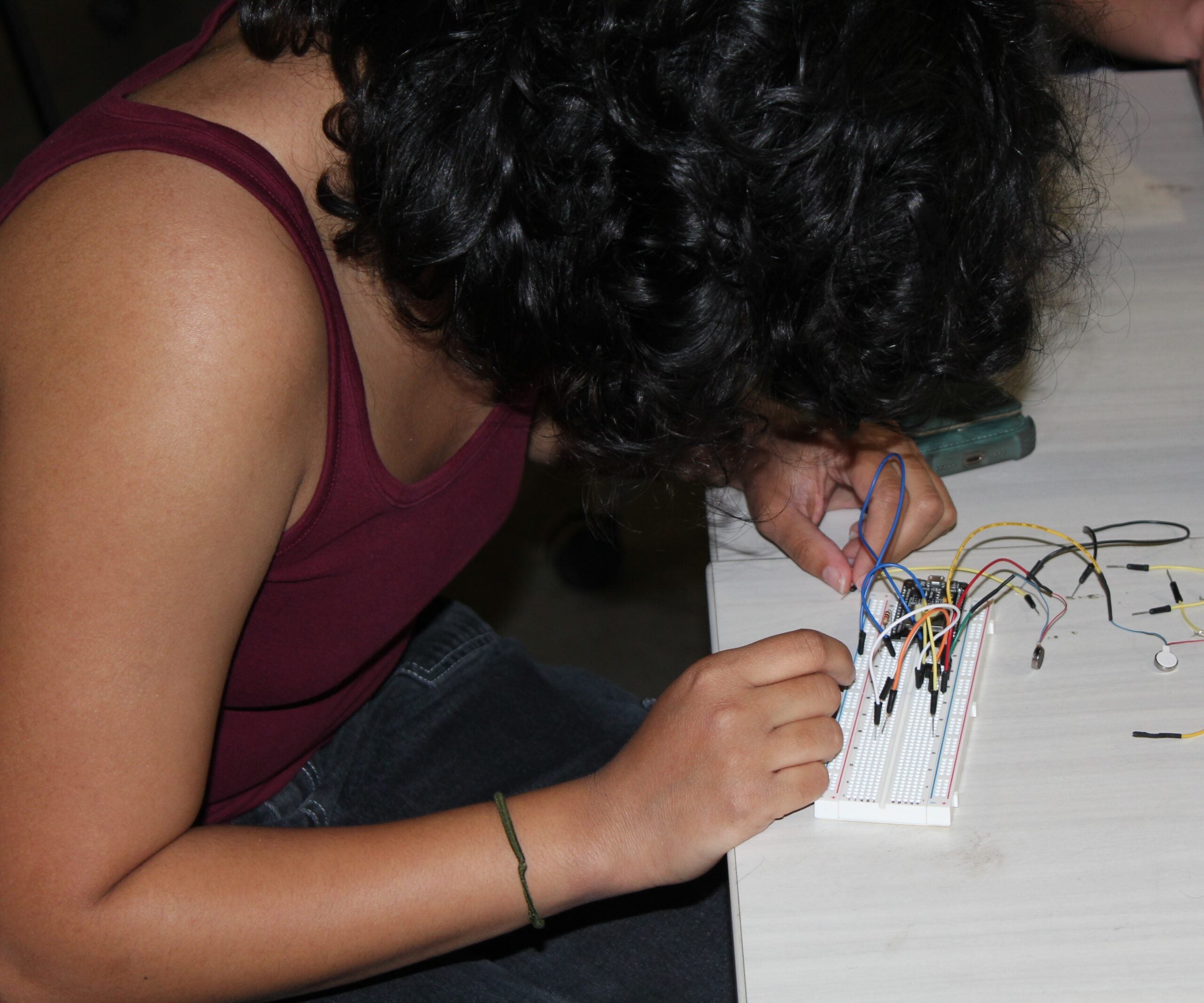Chandni Sharma works on wiring for a prototype haptic navigation device