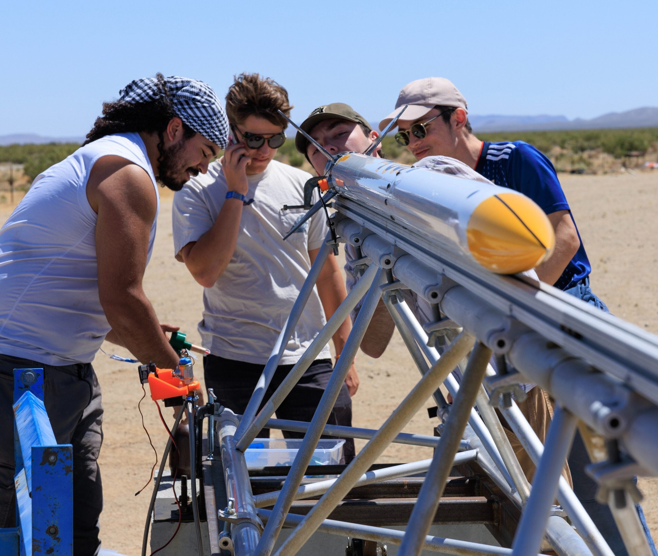 Let it Loose team members examine the engine of their rocket