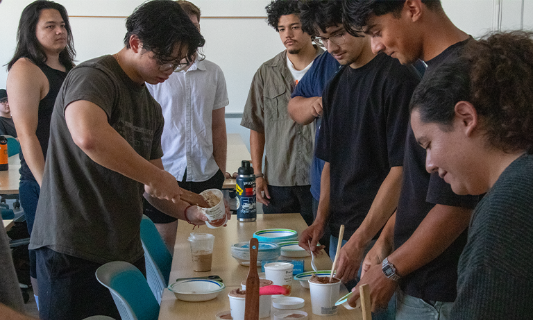 A group of students in a classroom scooping ice cream as a classroom treat.