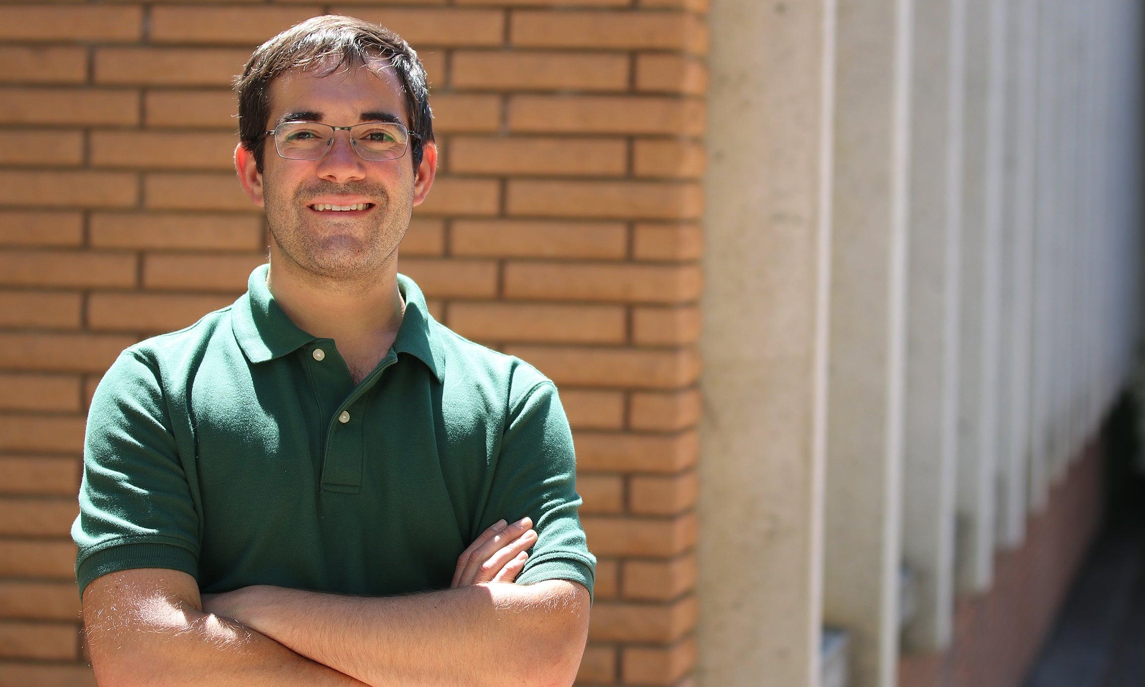 Professor poses on campus