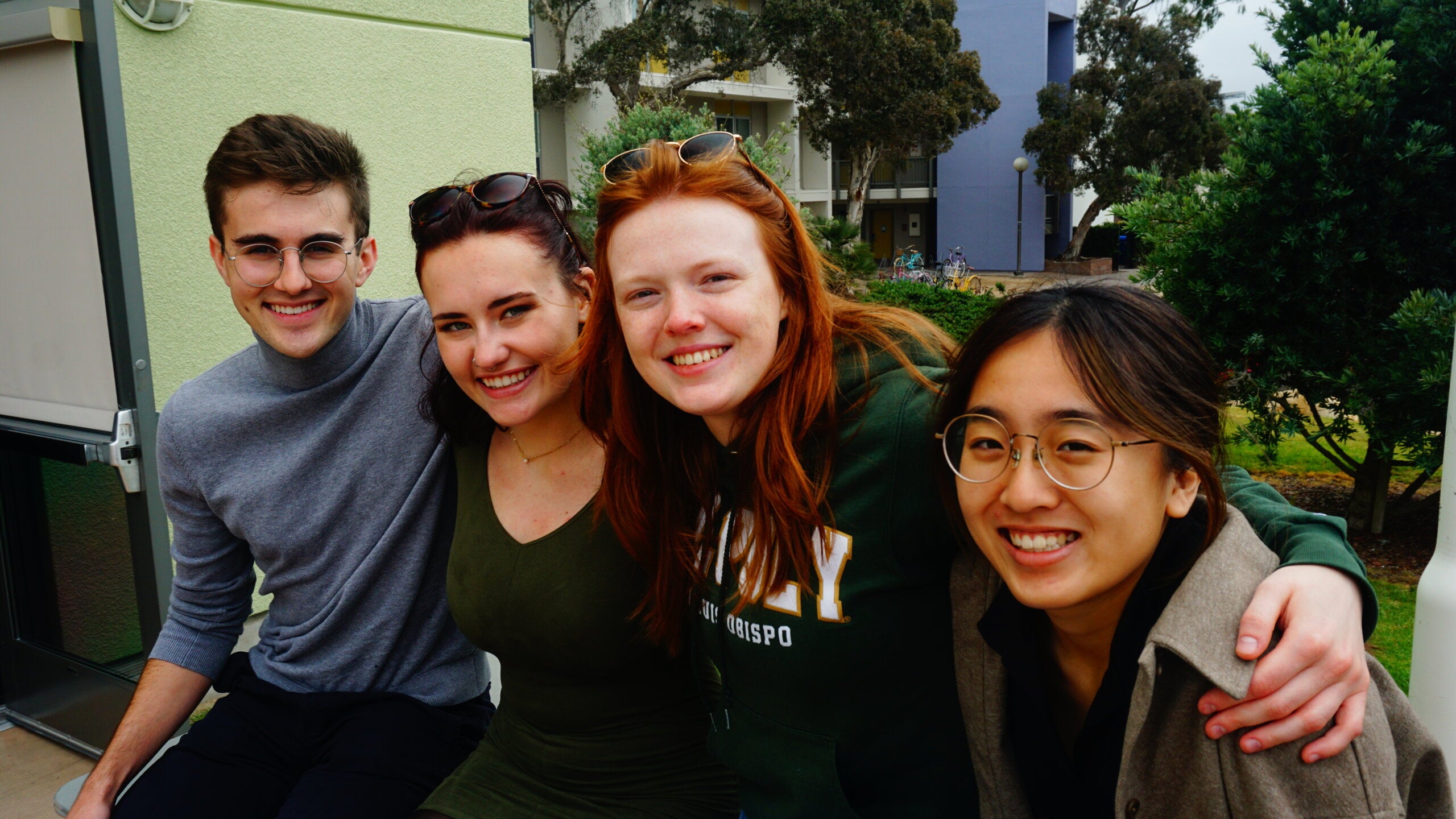 Four students pose for a photo