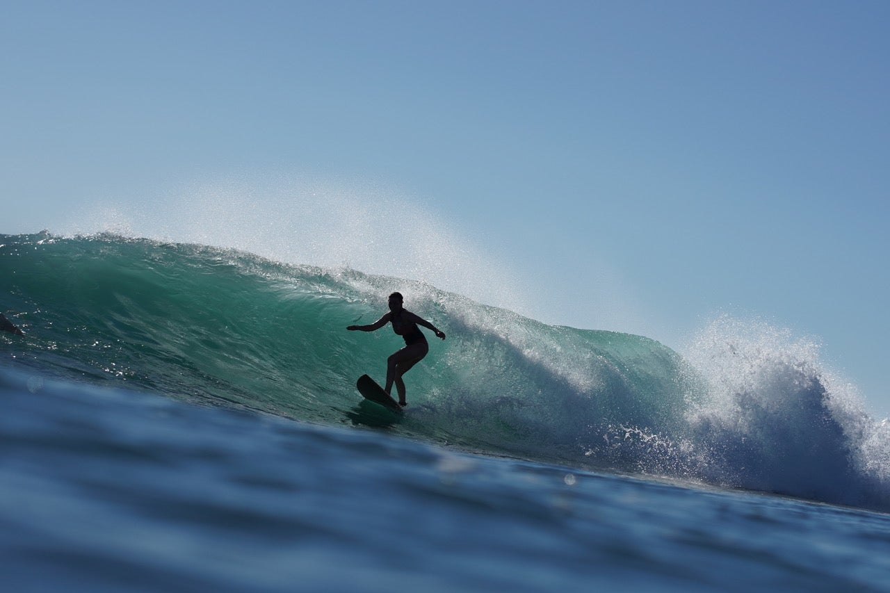 Serena Lee, an avid surfer, catches a wave in Australia
