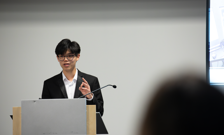 A person standing at a podium speaking